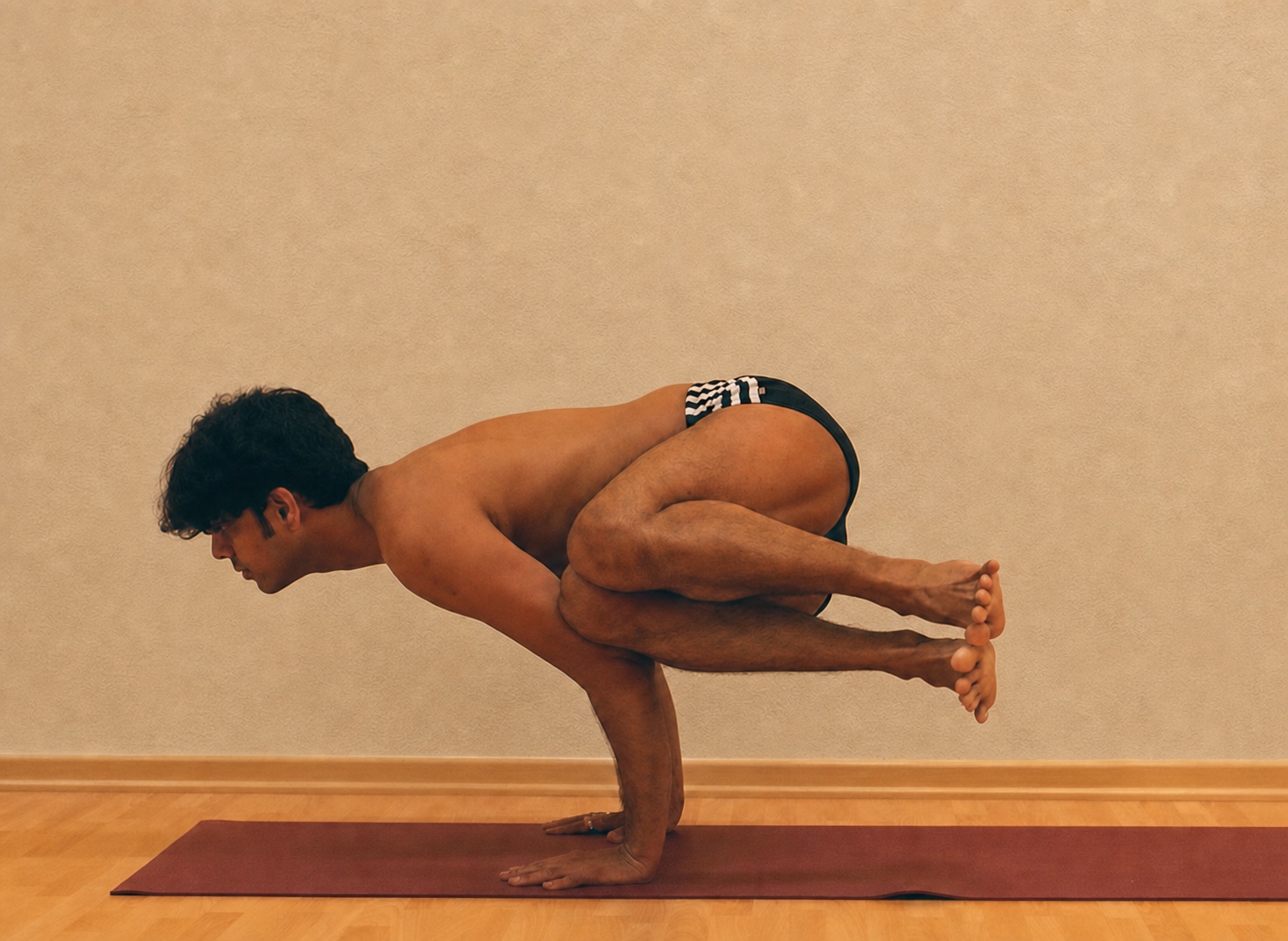 Parsva Bakasana yoga practice demonstrated by Pankaj Sharma